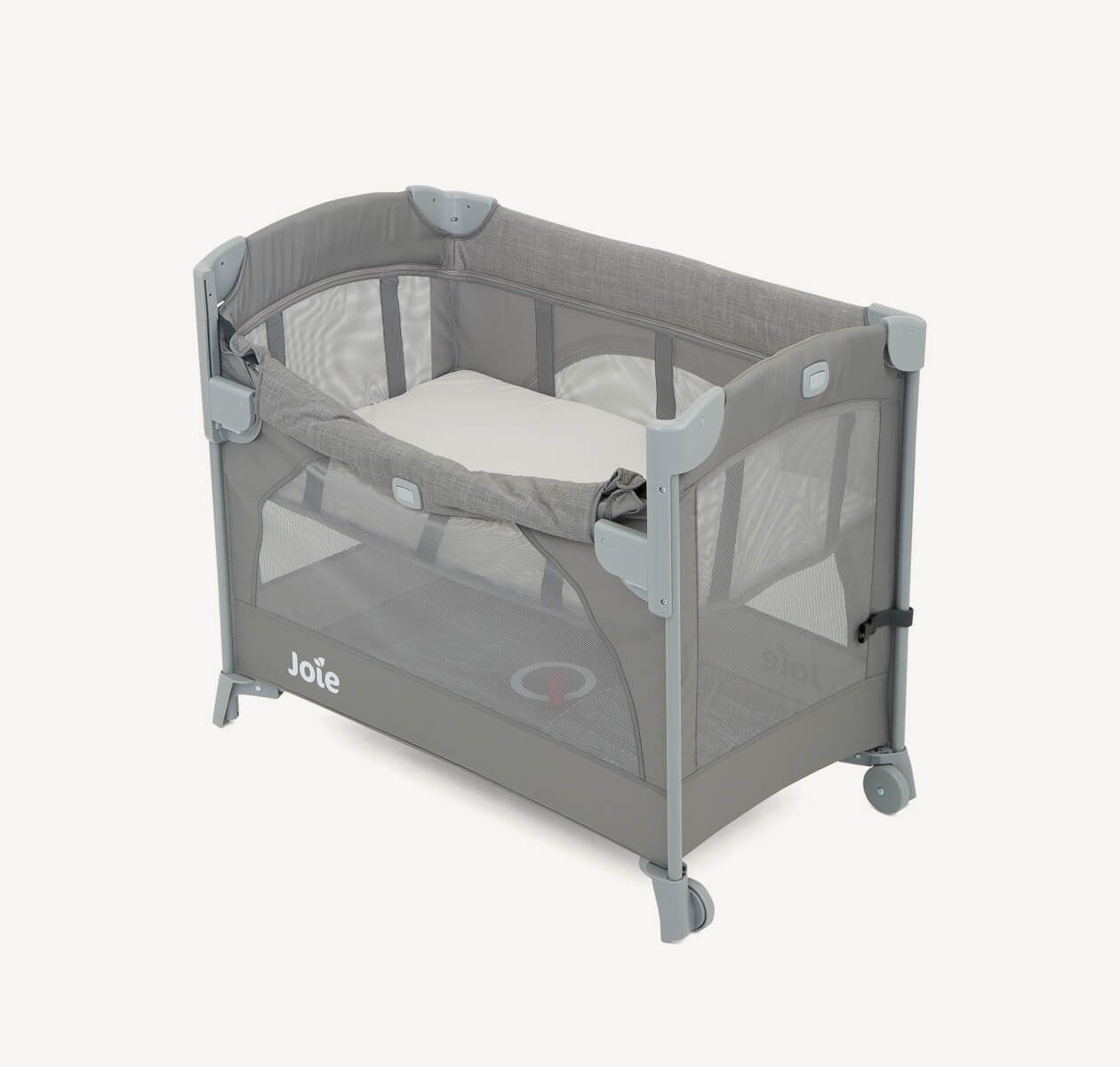Joie kubbie sleep bedside cot in gray with drop down side down at an angle.