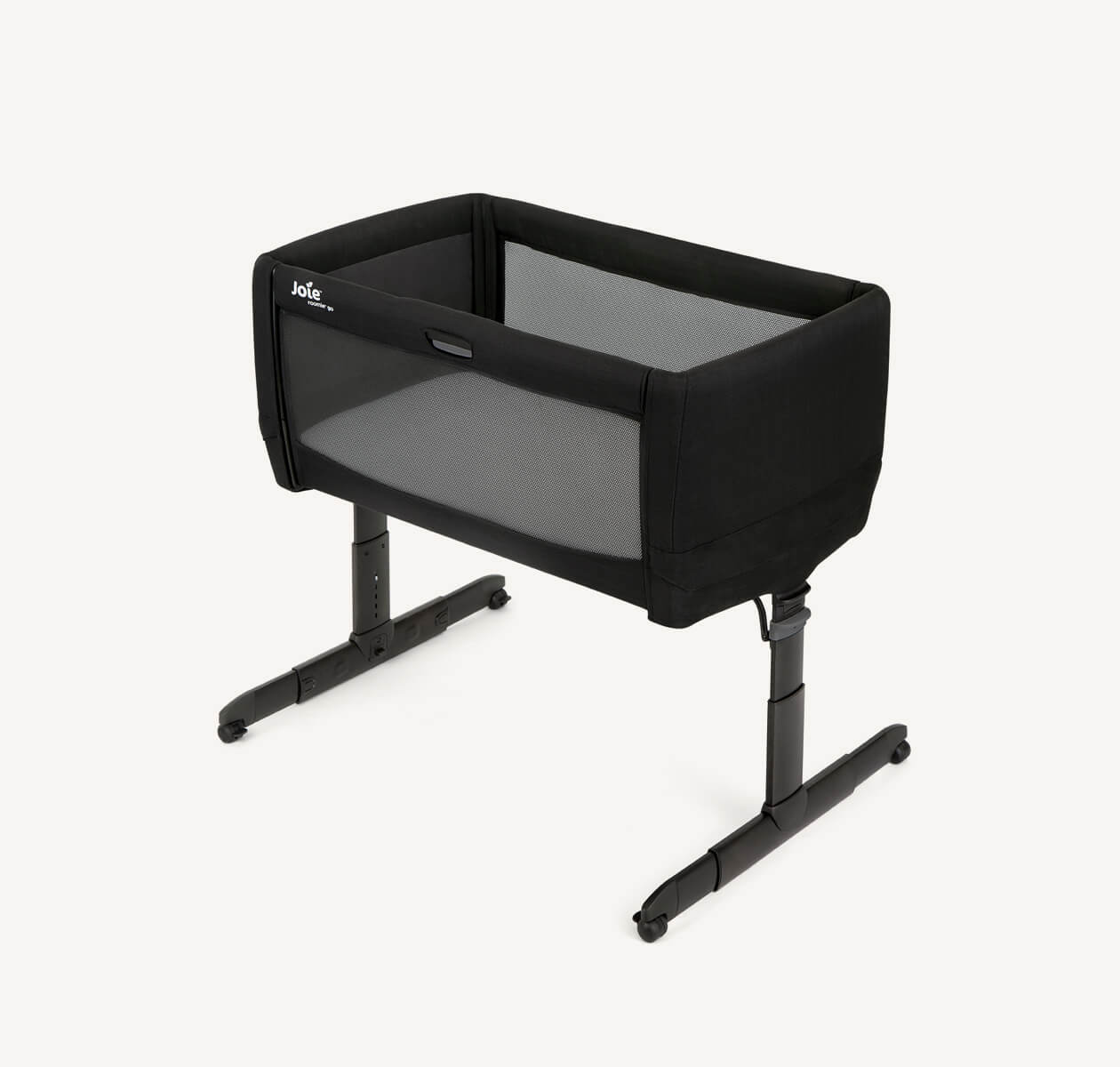 Black roomie go bedside travel crib facing straight on with the drop side raised.