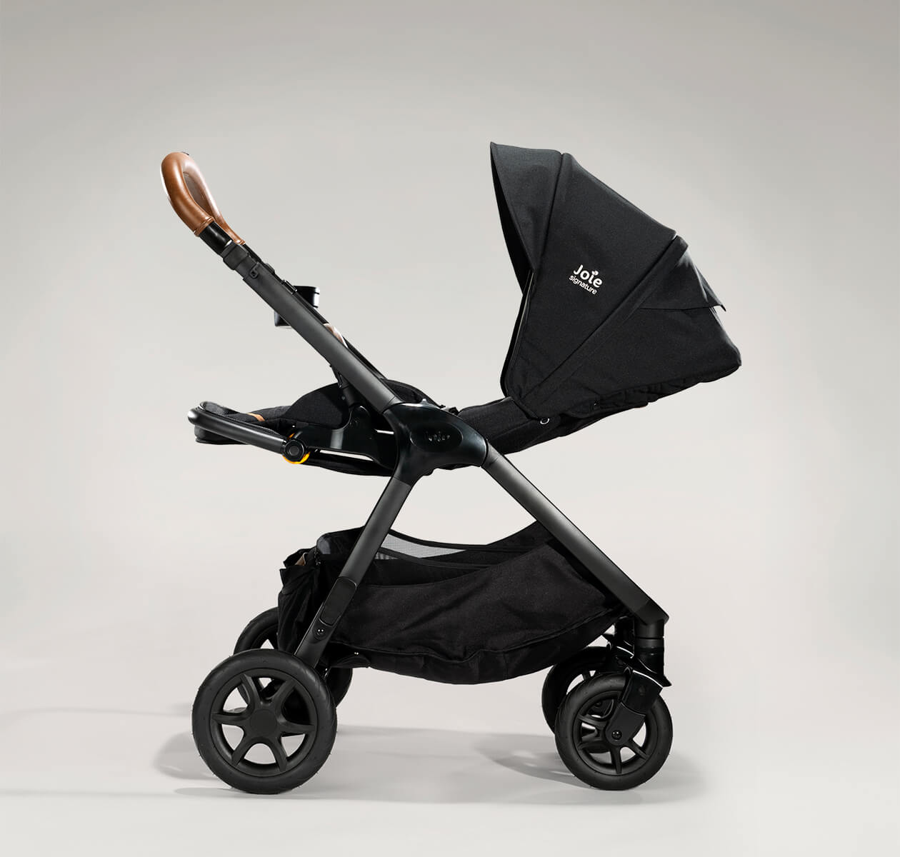 Joie finiti pram in black profile fully reclined facing to the left.