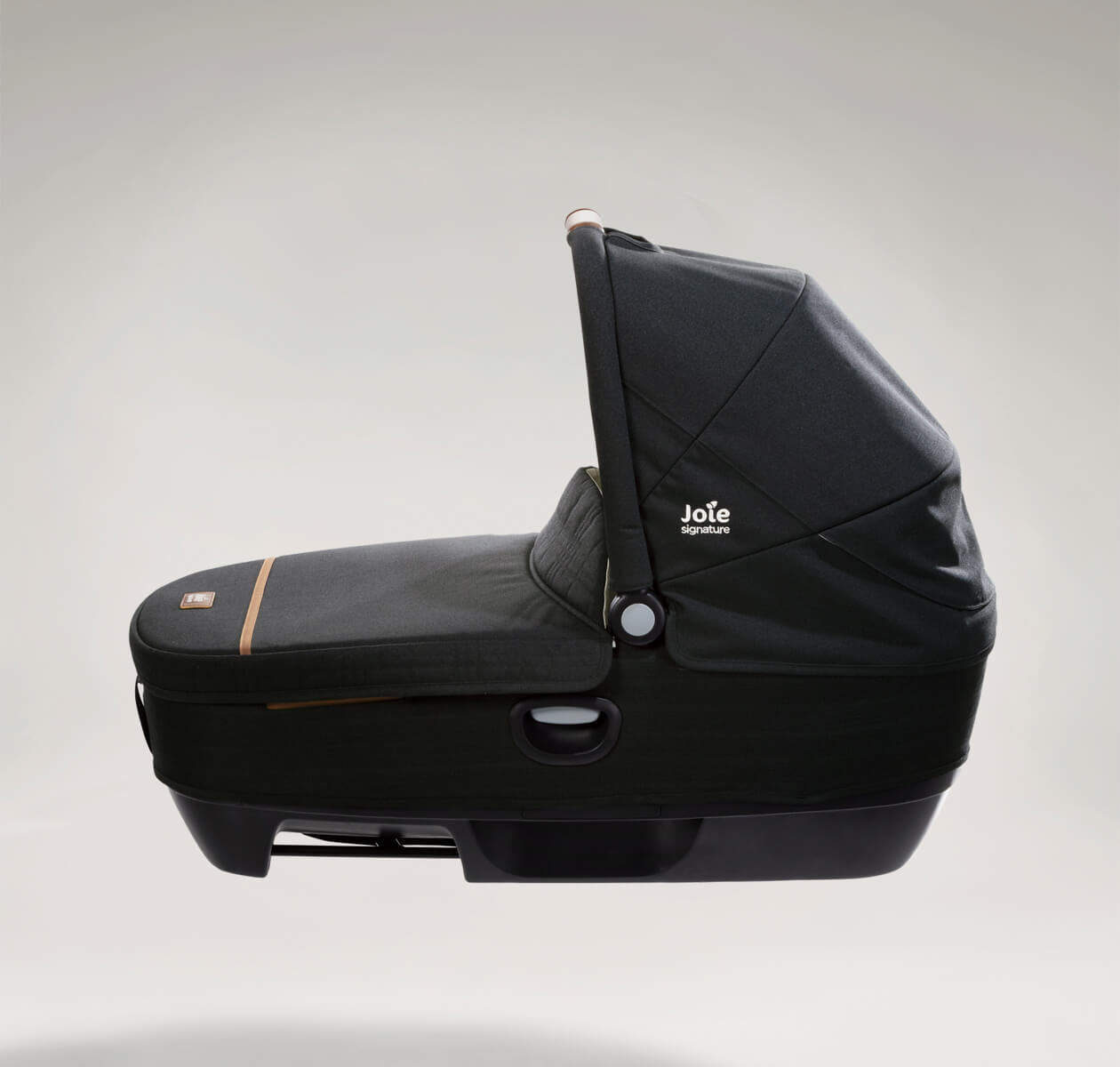 Joie Signature calmi R129 car cot in the color black eclipse with the canopy up and protective cover on facing left