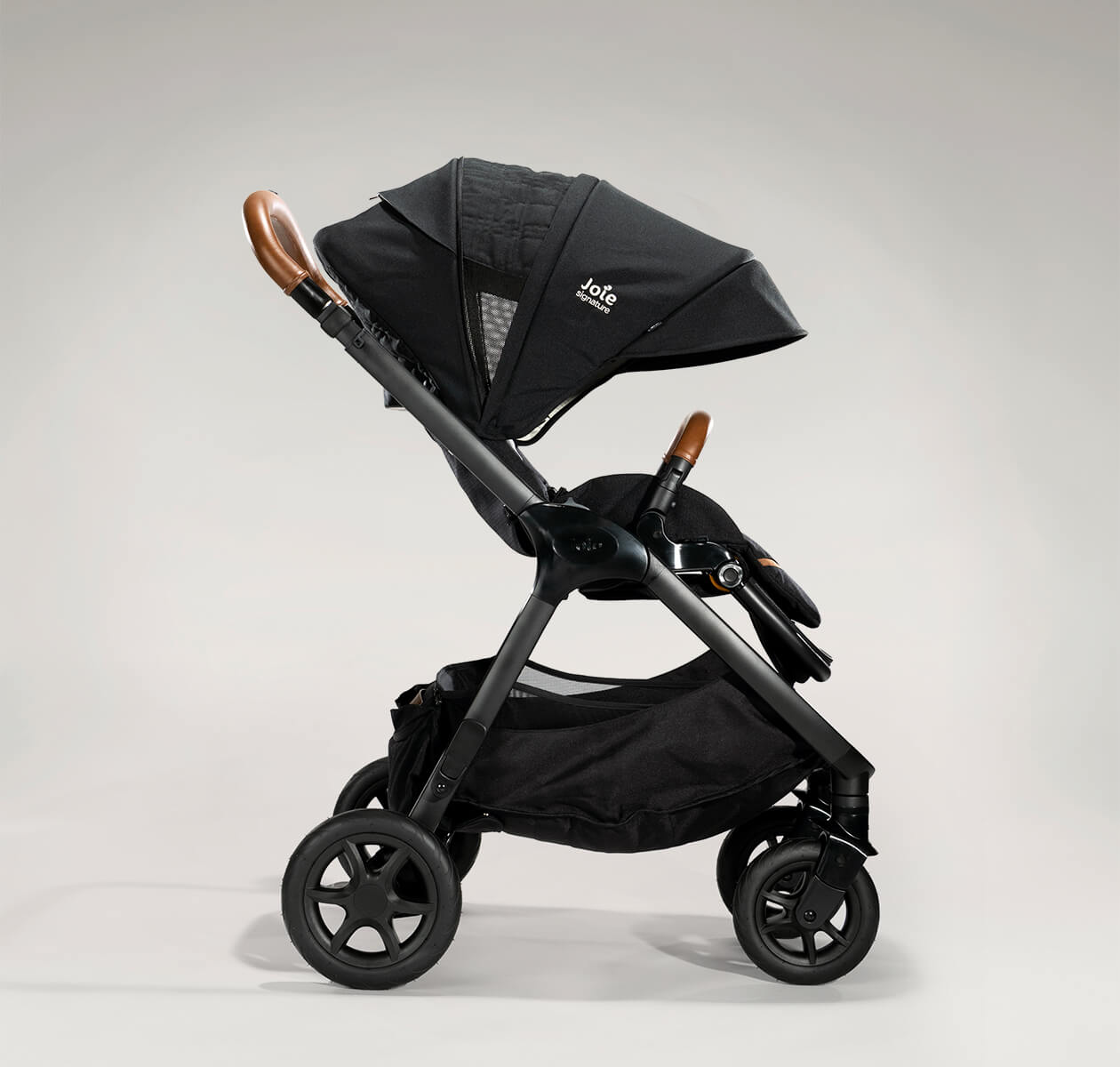 Joie finiti pram in black profile facing to the right with the canopy extended.
