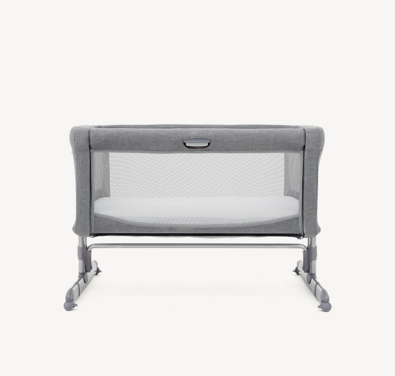   Front view of light gray Joie roomie bedside crib with legs lowered to ground.