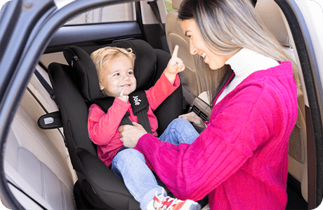 Joie car seat from a side view on a car seat base with a ruler icon to show a good fit on the seat.