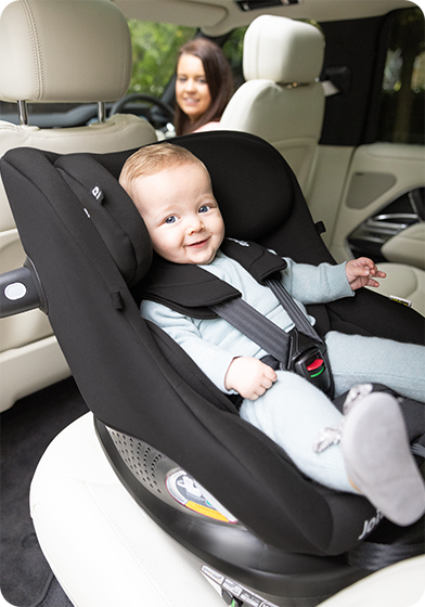 Joie i-Pivot 360 rear-facing car seat with smiling baby safely secured