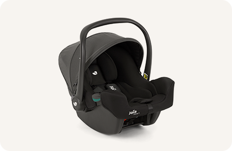 A black Joie i-Snug™ 2 infant car seat with a curved carry handle and sun canopy, shown on a light background.