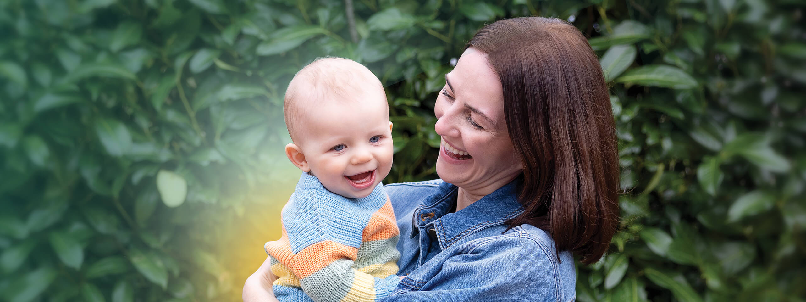 moeder lacht en houdt gelukkige baby vast.