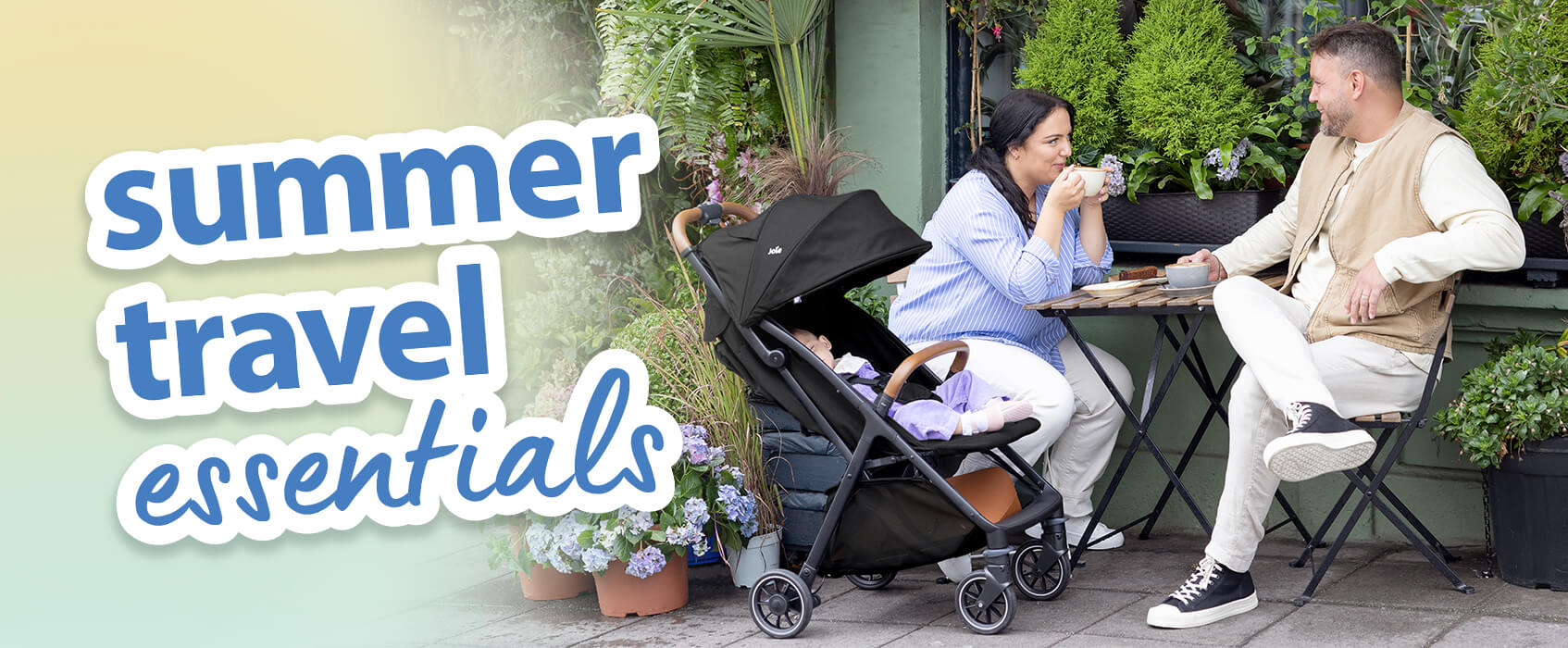 Parents chatting over coffee at a cafe table in an outdoor garden setting. Baby is relaxing comfortably next to them in the Joie pact pro pushchair. Text on the image is highlighting summer travel essentials.