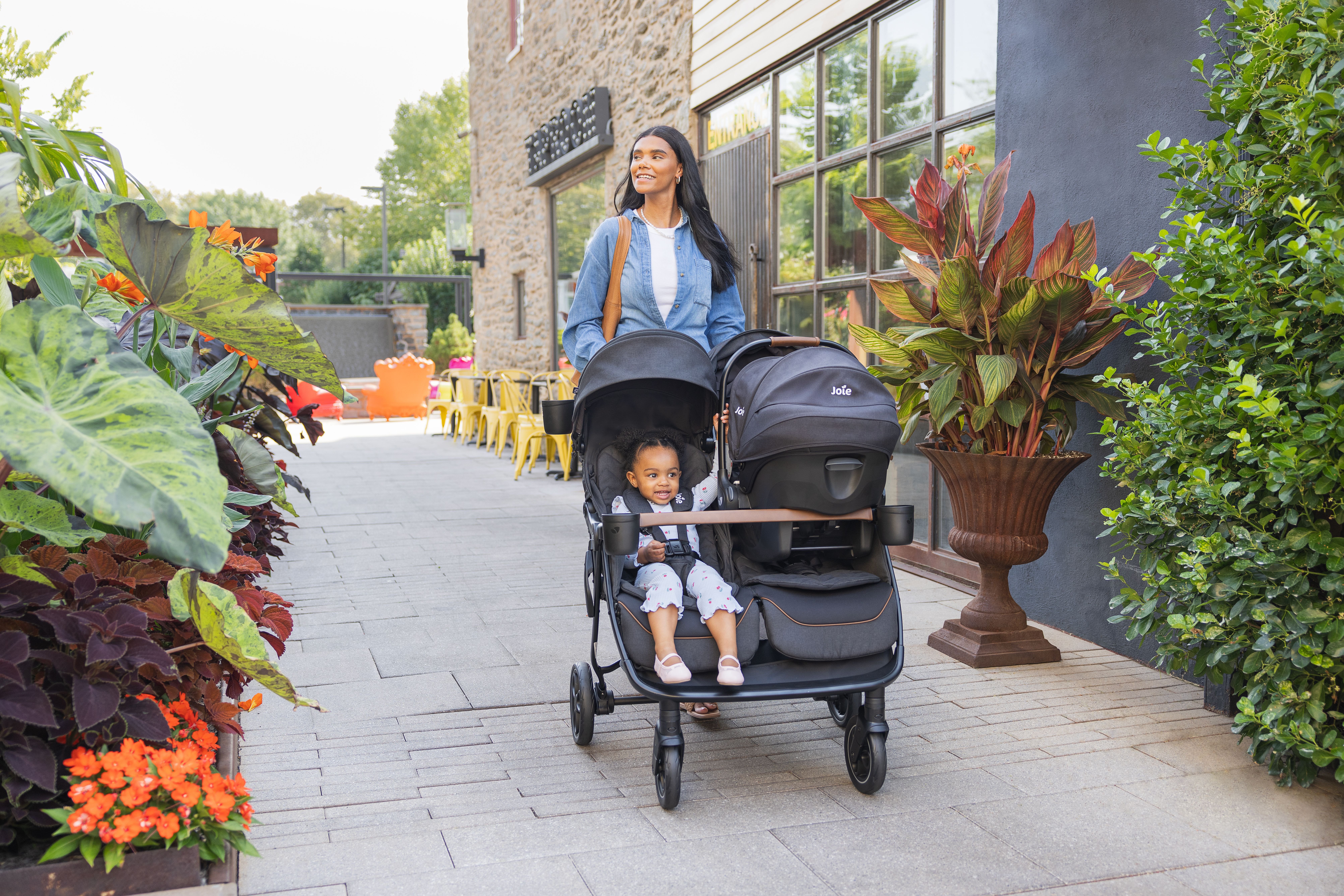 mother pushing children in rosemary lx stroller and car seat travel system.