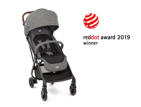 A gray Joie Signature i-Prodigi car seat at an angle facing to the right, with the Red Dot Design award logo above and to the right