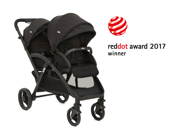 A gray Joie Signature i-Prodigi car seat at an angle facing to the right, with the Red Dot Design award logo above and to the right